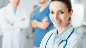 professional-female-doctor-posing-smiling-camera-medical-staff-working-backgroun.jpg