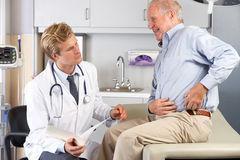 doctor-examining-male-patient-hip-pain-28851751.jpg